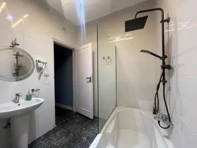 a bathroom with a shower and a tub and a sink at Nile Spirit Sunset in Luxor