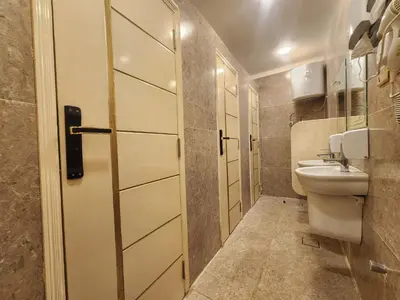 a small bathroom with a toilet and a sink at Hana Stay Hostel in Luxor