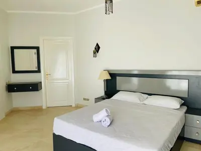 a bedroom with a bed with two towels on it at Luxury villa in gouna in Hurghada