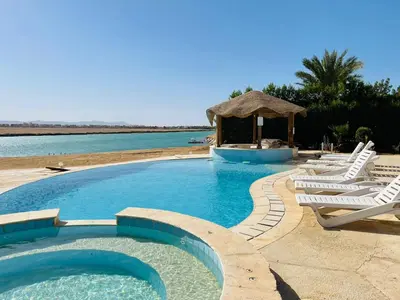 a swimming pool with lounge chairs and a gazebo at Luxury villa in gouna in El Gouna