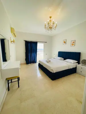 a large bedroom with a bed and a chandelier at Luxury vill in gouna in Hurghada
