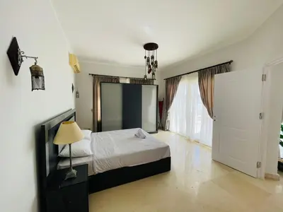 a bedroom with a bed and a large mirror at Luxury vill in gouna in Hurghada