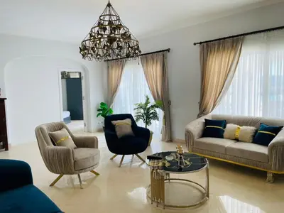 a living room with a couch and chairs and a chandelier at Luxury vill in gouna in Hurghada