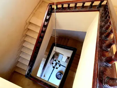 a mirror hanging on a wall next to a staircase at Villa Rosamund in Luxor