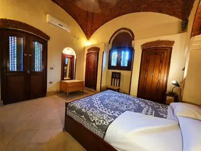 a bedroom with a bed in a room at Villa Rosamund in Luxor
