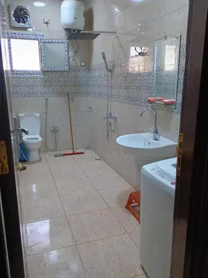 a bathroom with a toilet and a sink at Families only in Al ‘Izbah wa al ‘Arab