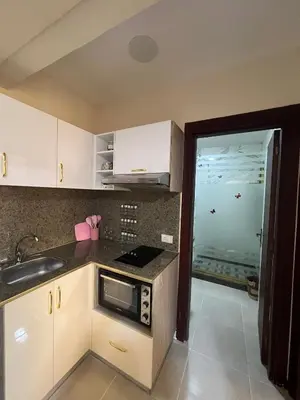 a kitchen with a sink and a microwave at Tiba Gold in Hurghada