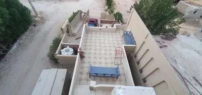 an overhead view of a house with blue chairs and a driveway at Mountain house in ‘Ezbet Abu Ḥabashi