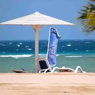 a pair of chairs and an umbrella on a beach at Selena bay resort in Hurghada