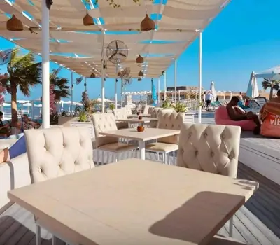 a restaurant with white chairs and tables on a deck at Selena bay resort in Hurghada