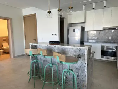 a kitchen with a counter with chairs and a counter top at Fanadir Marina Vista in Hurghada