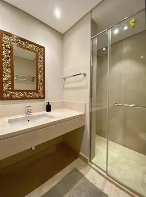 a bathroom with a sink and a glass shower at Stylish Gouna Mangroovy Retreat in Hurghada