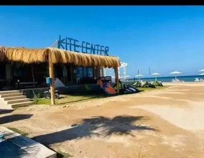 a building with a straw roof on the beach at Selena bay resort in Hurghada