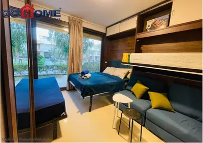a bedroom with a bed and a bed and a couch at Cozy Studio 1BR G Cribs b19-g7 El-Gouna Shared Heatd Pool in El Gouna