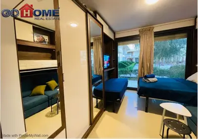 a small bedroom with a bed and a mirror at Cozy Studio 1BR G Cribs b19-g7 El-Gouna Shared Heatd Pool in El Gouna