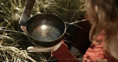 a woman holding a metal bowl in her hand at MGM Wellness Retreat in Aswan