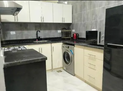 a kitchen with a sink and a washing machine at Hurghada European style in Hurghada