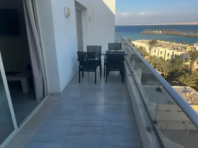 a balcony with chairs and a view of the ocean at Scandic sea view in Hurghada