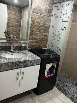 a bathroom with a sink and a trash can at Scandic sea view in Hurghada