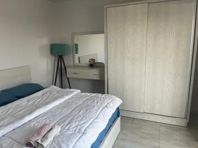 a bedroom with a white bed and a mirror at Scandic sea view in Hurghada
