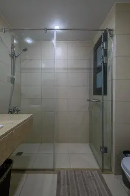 a bathroom with a shower with a glass door at Brand New Shedwan Spacious 1Bdr in Hurghada