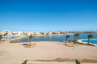 arial view of a beach with palm trees and buildings at Brand New Shedwan Spacious 1Bdr in Hurghada