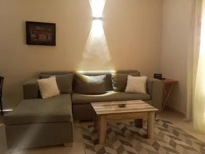 a living room with a couch and a coffee table at Casablanca Resort A F in Hurghada