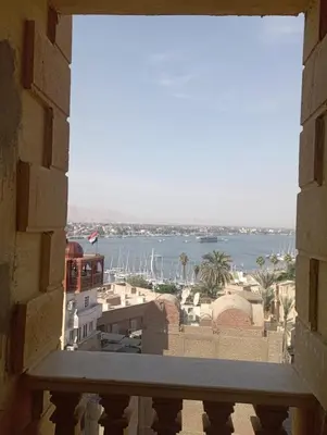 a view of the water from a window at شقه على النيل in Luxor