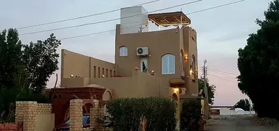 a large house with a lot of windows on it at House Mountain Luxor - Villa for rent in Luxor