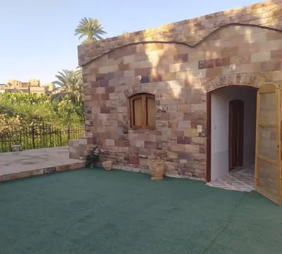 a stone building with a patio and a door at Old Nile Retreat in Luxor