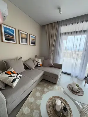 a living room with a couch and a large window at Somabay-Mesca - Relaxing Ground Floor in Hurghada