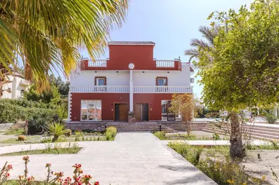 an exterior view of a red and white house at Elaskary in Hurghada