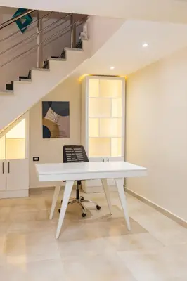 a white desk in a room with a staircase at Elaskary in Hurghada