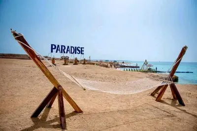 a hammock on a beach with the words paradise at Contesa Do in Hurghada