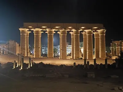 a building with columns in front of a city at night at Jamaica Dream in Luxor