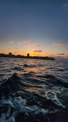 a body of water with a sunset in the background at City centre Carrefour in Hurghada