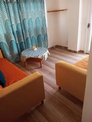 a room with two beds and a table in it at City centre Carrefour in Hurghada