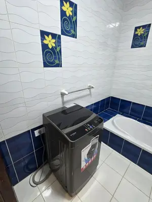 a blue and white bathroom with a trash can at شقة لاروز الغردقه الكوثر القديم شارع النور عماره لاروز in Hurghada