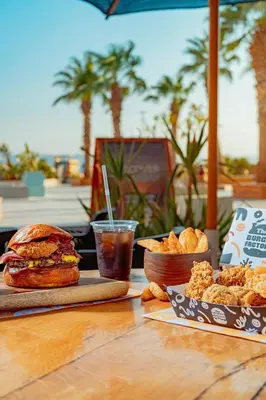 a table with a sandwich and a bowl of food at The Kaktus Somabay in Hurghada