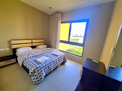 a bedroom with a bed and a window at Gouna -tawila in Hurghada