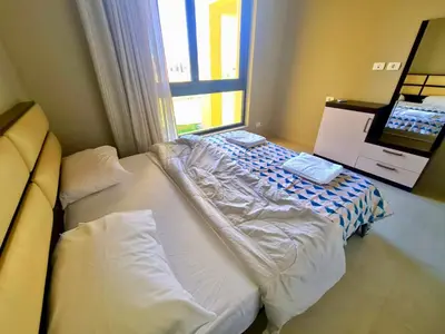 a large bed in a room with a window at Gouna -tawila in Hurghada