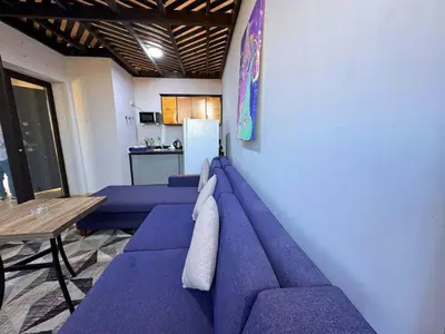 a room with purple couches against a wall at ALDAU LaLa in Hurghada