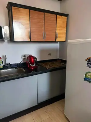 a kitchen with a sink and a refrigerator at ALDAU LaLa in Hurghada
