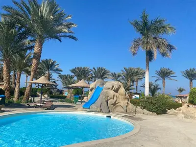 a pool at a resort with a slide at vintage sea view apartment in Hurghada