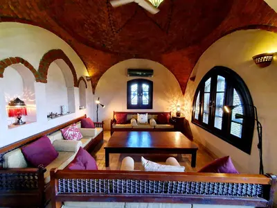 a living room with a couch and a table at Riverbank House in Luxor