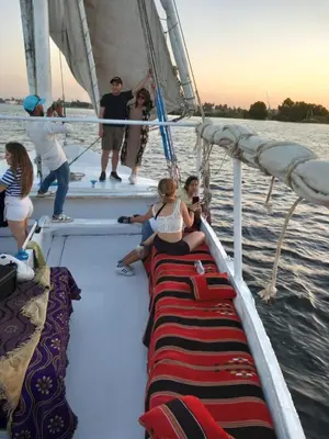 a group of people on a sail boat in the water at جزيرة العوامية in Luxor