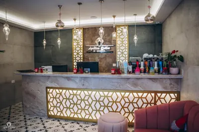 a lobby with a bar with a pink chair at Arаbian Suites by Imperial in Hurghada