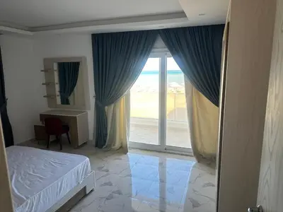 a bedroom with a bed and a large sliding glass door at Sea view chalet hurghada in Hurghada
