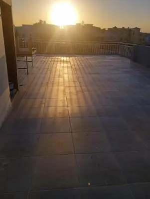 a view of the sun setting on a balcony at Studio in Villa in Hurghada
