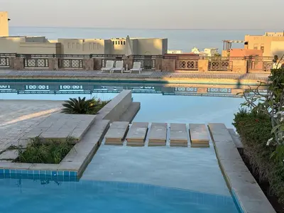 a swimming pool with a view of the ocean at Cozy studio in Azzurra Resort Sahl Hasheesh 65 Sq M in Hurghada